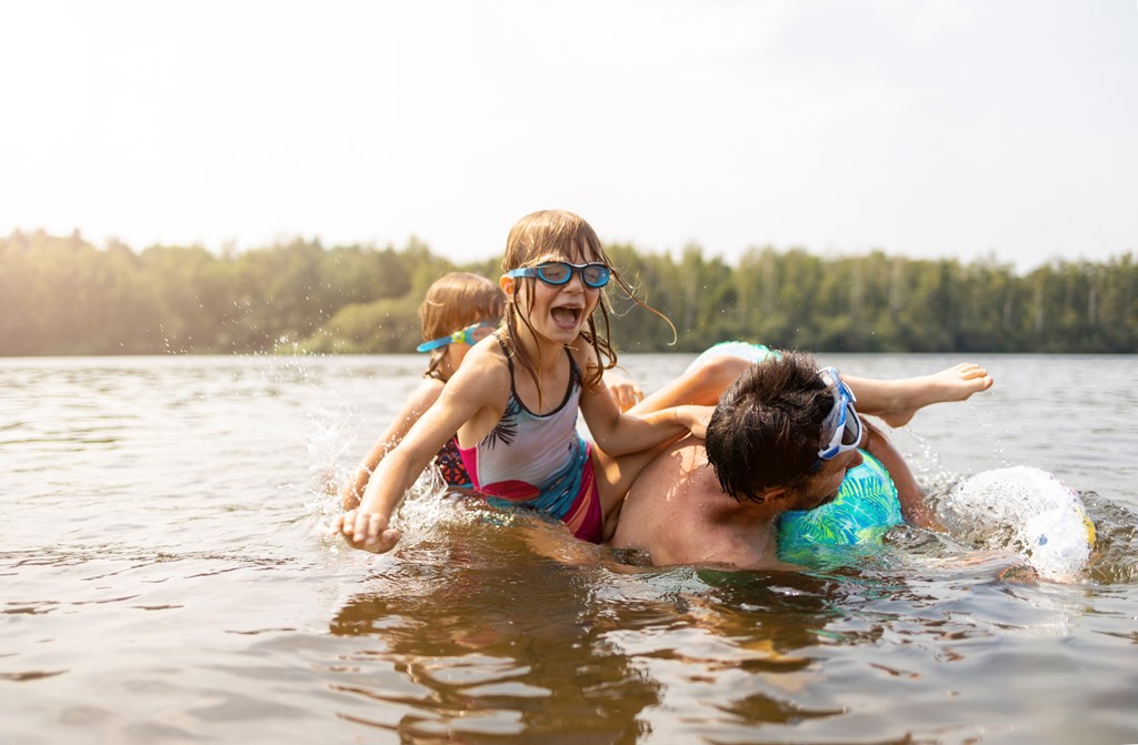 Father and kids having fun in the lake.