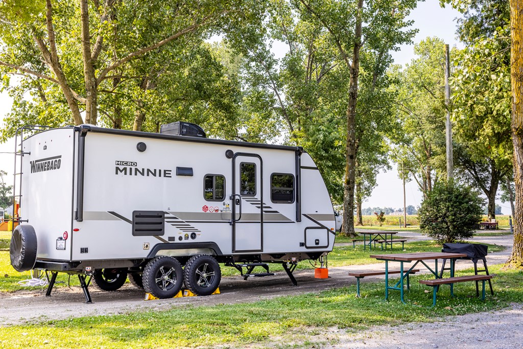 A small travel trailer set up at a KOA campground.