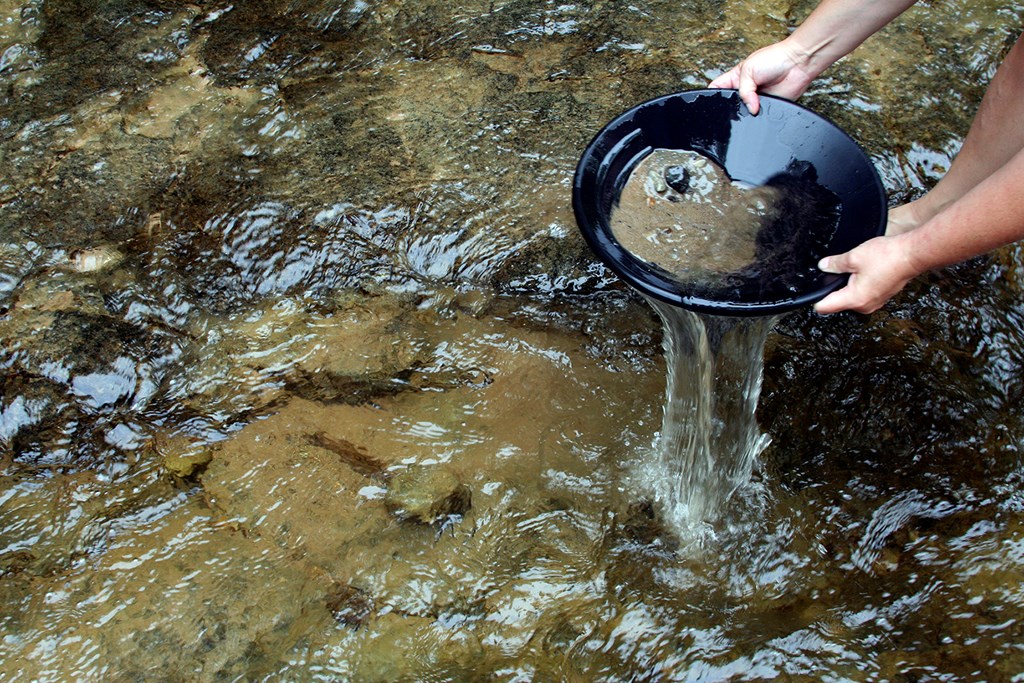 Panning for gold in a stream