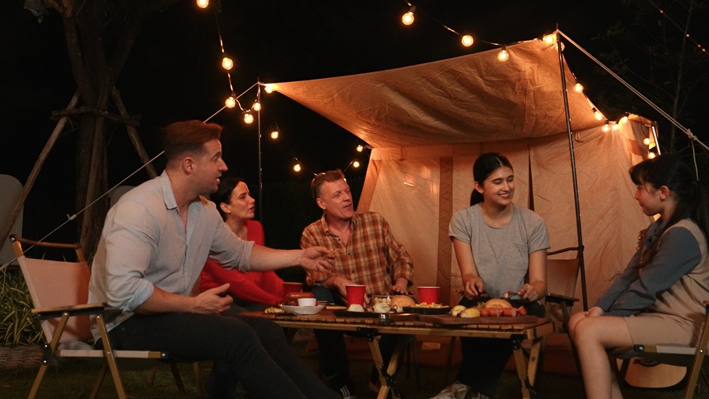 Family gather for holiday celebration in garden. Family member gather have dinner. Outdoor camping activity to relax with food and spend time with younger generation cross generation gap. Divergence.