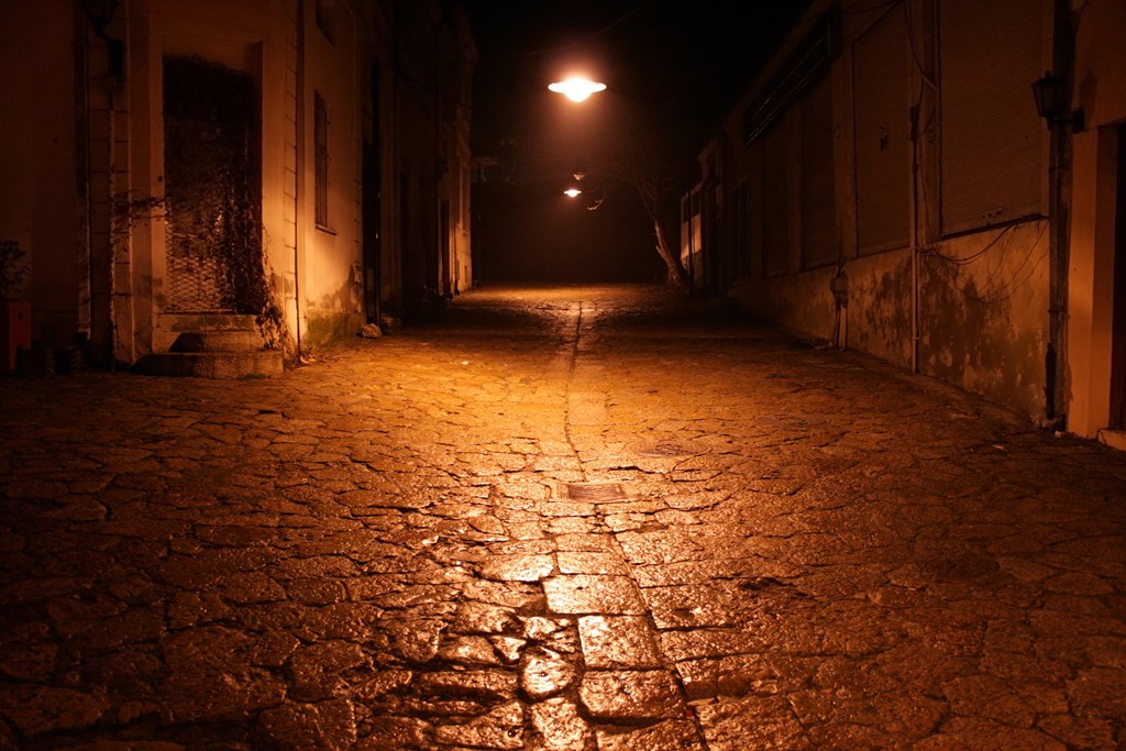 A cobblestone street with street lights paints the scene for the kids ghost story called A Town Named 1234