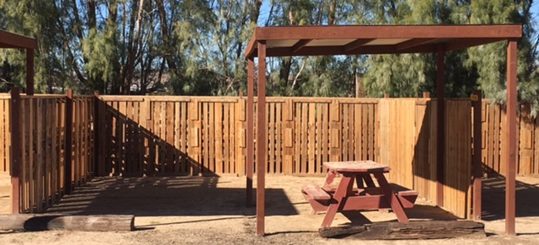 Privacy fence with shaded picnic table